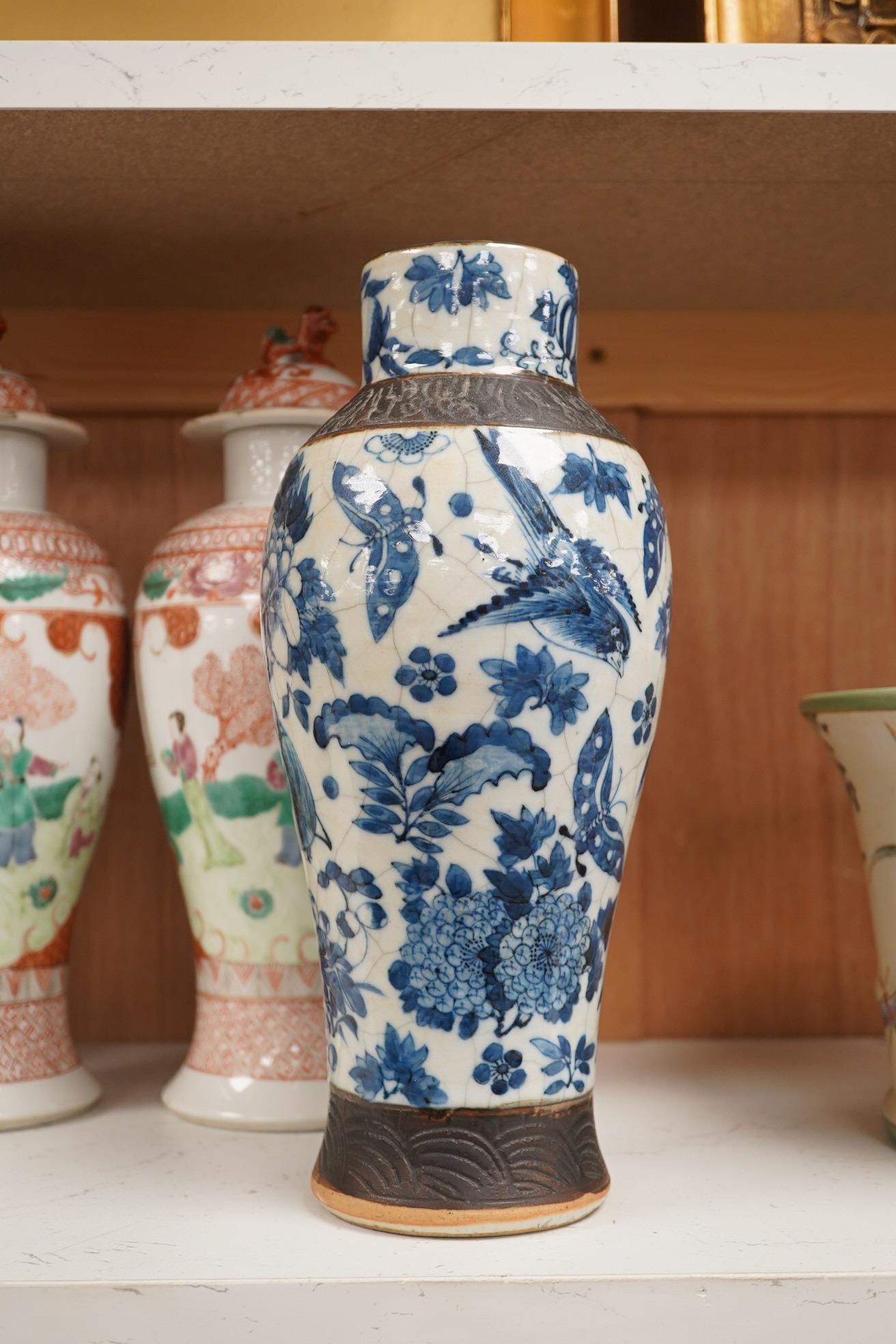 A group of Chinese ceramics to include a pair of early 20th century famille rose vases and covers, a 19th century blue and white crackle glazed vase etc, largest 31cm high. Condition - mostly fair, a few chips and cracks